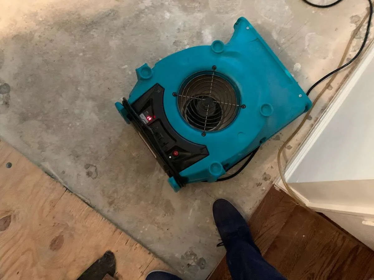Air mover drying subfloor during Commercial Water Damage Restoration in North Lebanon